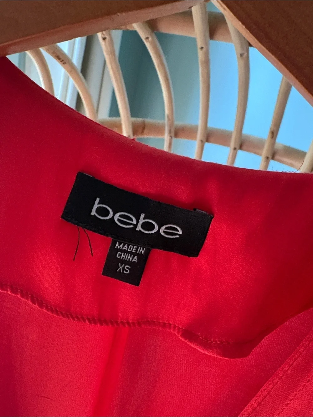 Beautiful Bebe satin vibrant red/orange romper with gold accents.